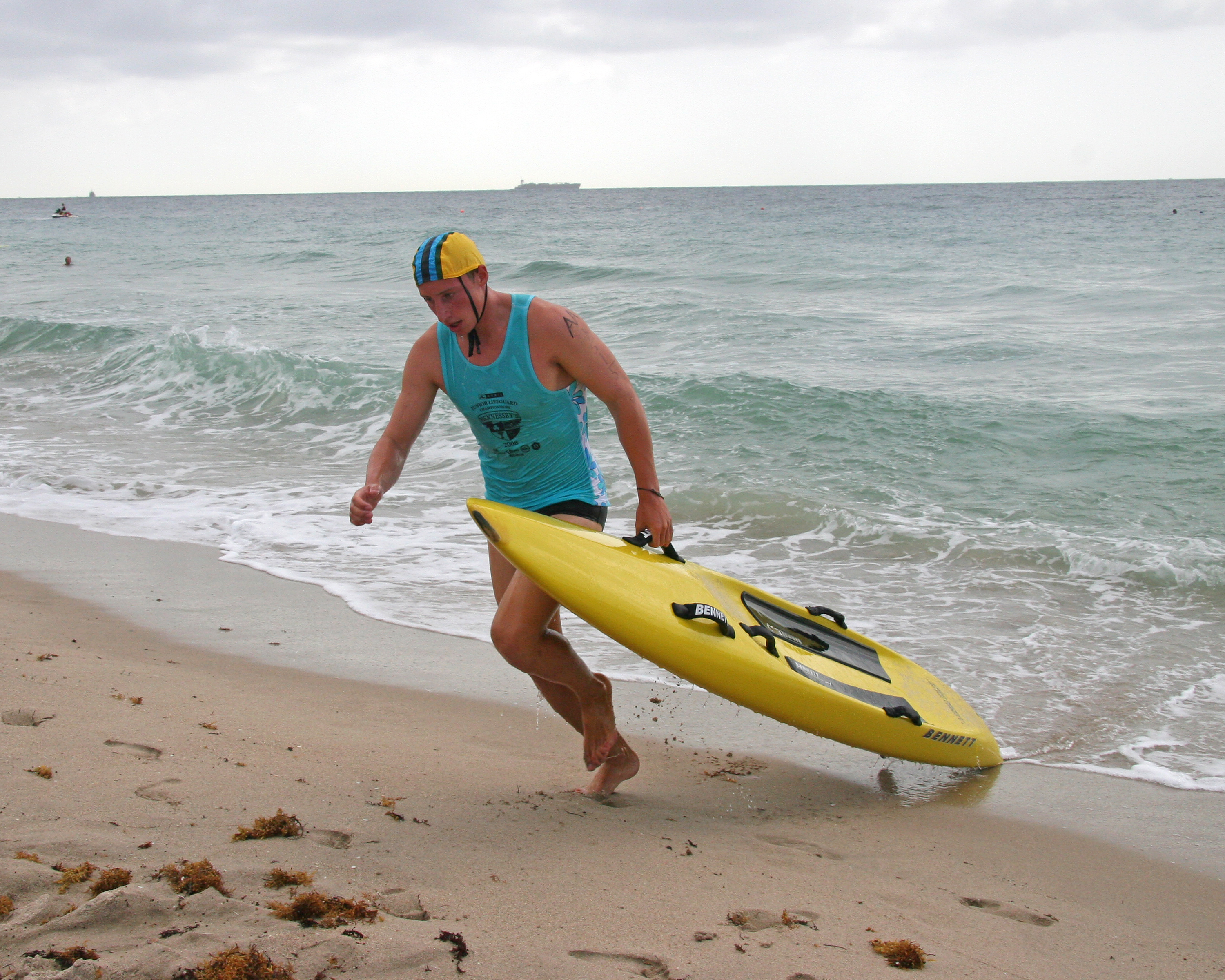 Will Rogers' Ben Lewenstein drags his board up the beach on his way to winning the Paddleboard Race at the National Lifeguard Championships.